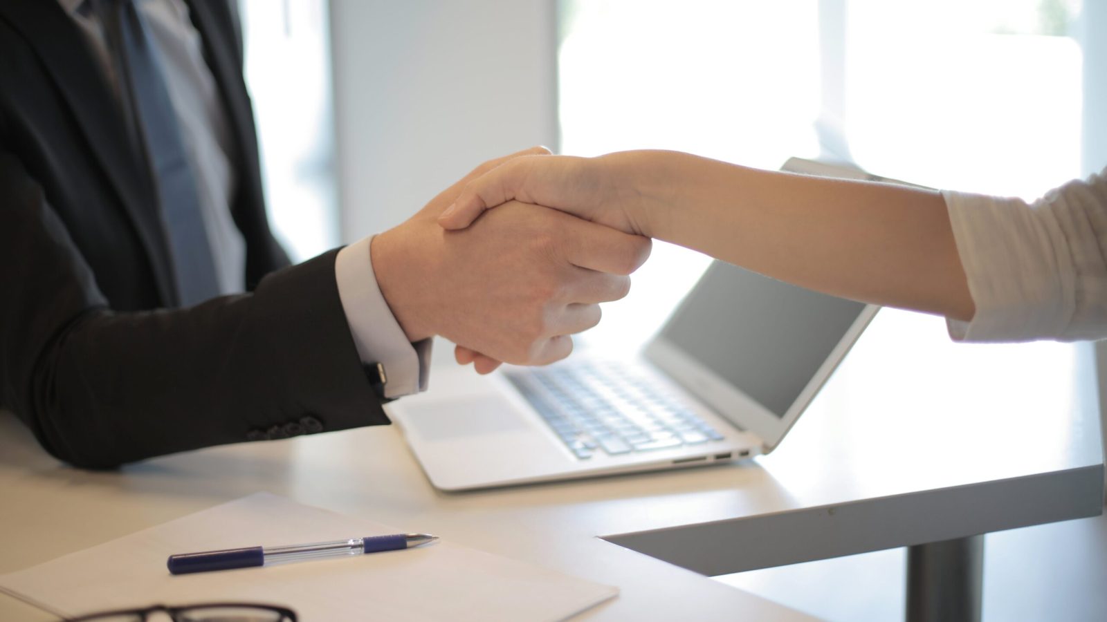 Explore business partnerships and professional connections with a handshake in Des Moines, Ankeny, and throughout Iowa.