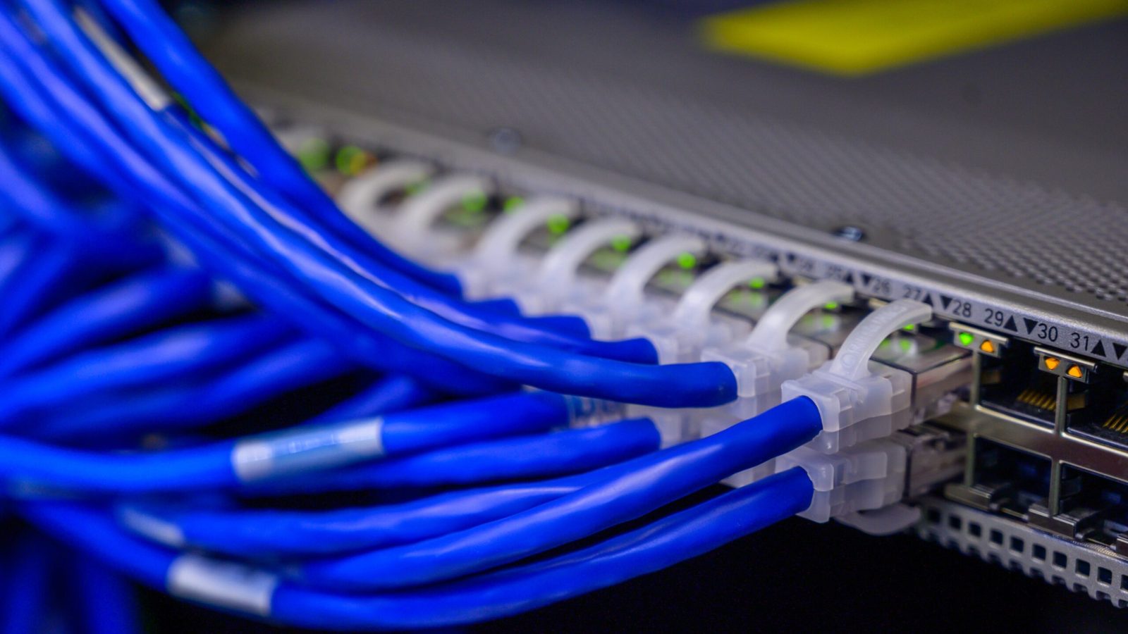 Discover our structured cabling solutions with meticulously organized Ethernet cables seamlessly plugged into routers. Elevate your connectivity experience with Comtek. Serving Des Moines, Ankeny, and all of Iowa.